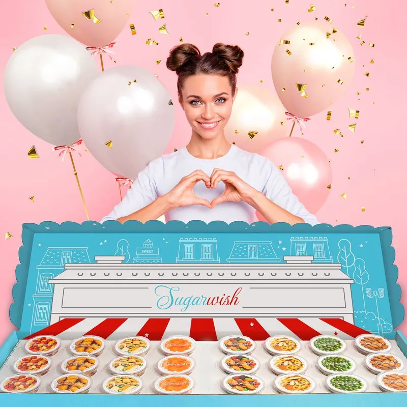 Woman making a heart shape with her hands at a birthday celebration with Sugarwish treats