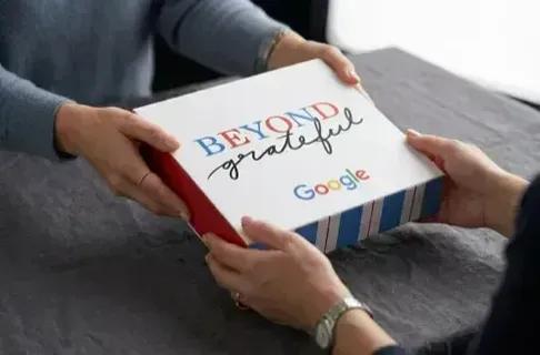 Custom branded gift sleeve wrapped around a Sugarwish box with a company logo