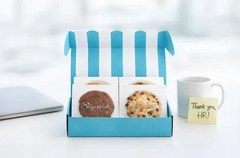 An open Sugarwish gift box on a desk with a Thank You HR sticky note