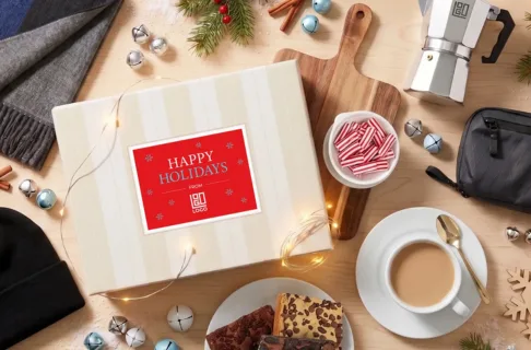 The 2026 Holiday Reserve branded gift box by Sugarwish surrounded by holiday items