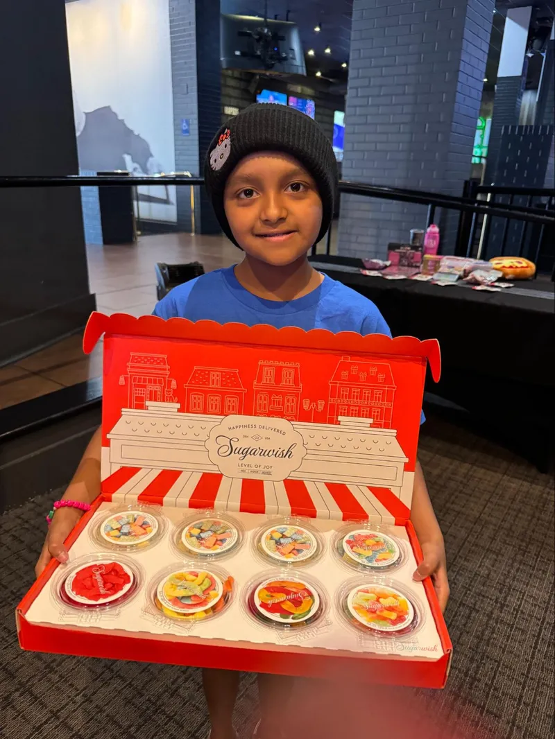 A boy holding sugarwish gift