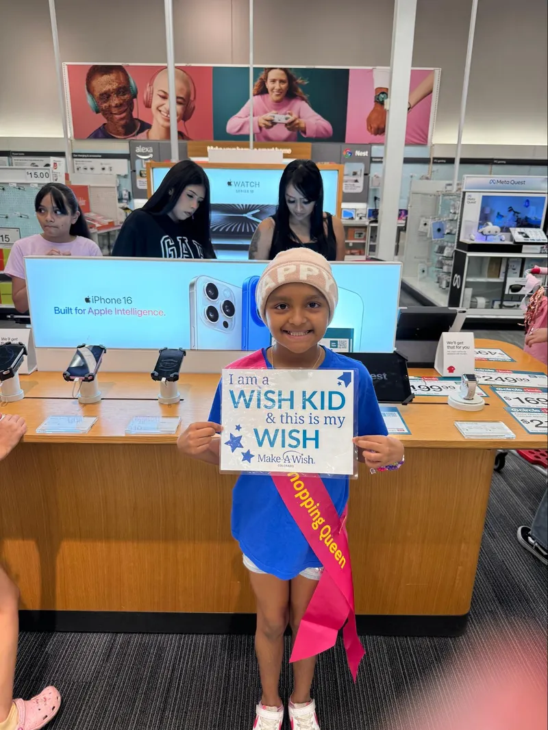 a boy holding make-a-wish gift card