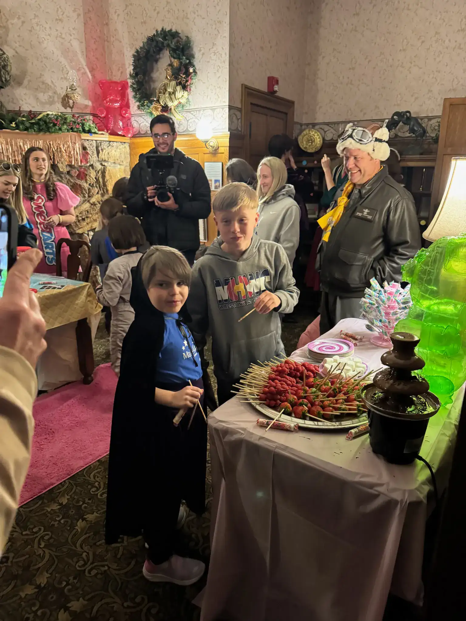 Gar and a friend at the chocolate fountain dipping marshmallows in the Sugarwish candy room