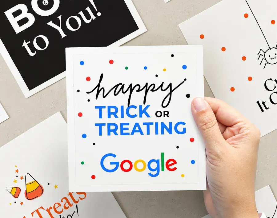 Hand holding a Halloween-themed Sugarwish note card reading Happy Trick or Treating with Google logo