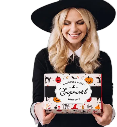Smiling customer in a witch costume holding a Sugarwish Halloween gift box