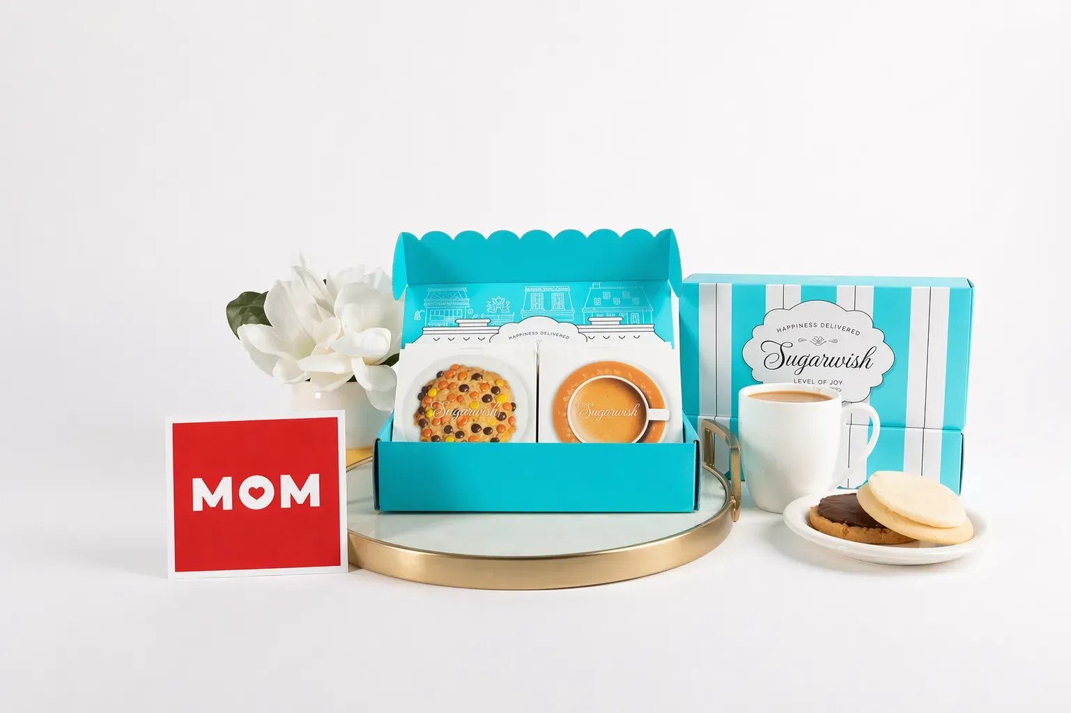 Sugarwish Mother's Day box with cookies, tea, and a MOM card on a gold tray
