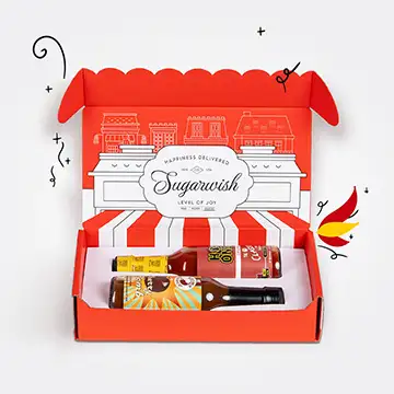Hot Sauce gift set with assorted bottles in a red-striped Sugarwish box