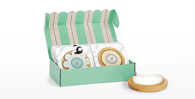 Mint green and cream striped gift box full of spa treatments